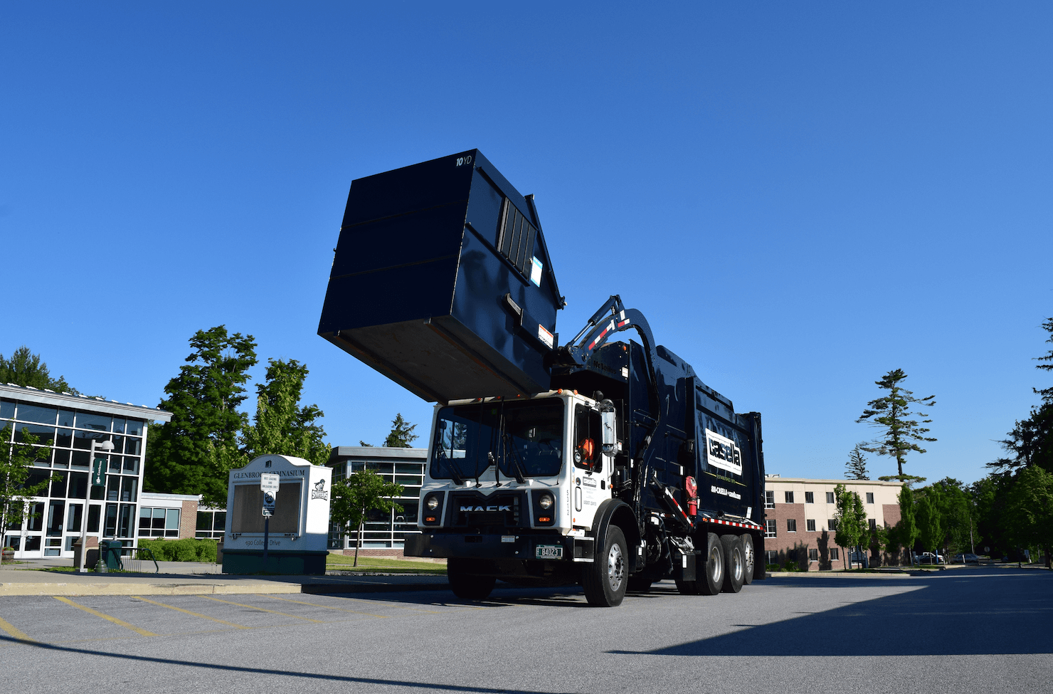 Forklift operator transporting compressed bales of recyclable materials at a Casella recycling facility.