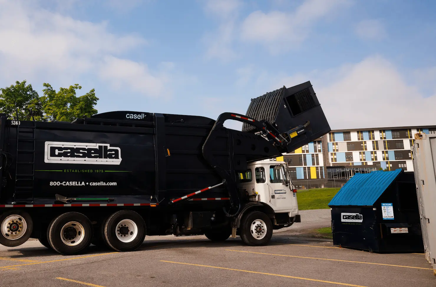 Casella front-load truck at commercial dumpster